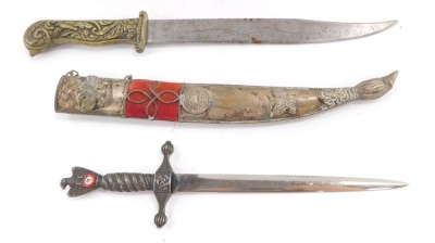 A Balkan dagger, commemorating The Greek War, the knife with brass handle, embossed with birds and scrolling leaves, the blade engraved with scrolling leaves and 1821, the sheath embossed with various emblems, 31.5cm high, together with a Kriegsmarine WWI