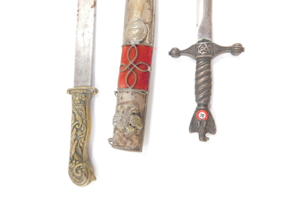 A Balkan dagger, commemorating The Greek War, the knife with brass handle, embossed with birds and scrolling leaves, the blade engraved with scrolling leaves and 1821, the sheath embossed with various emblems, 31.5cm high, together with a Kriegsmarine WWI - 2