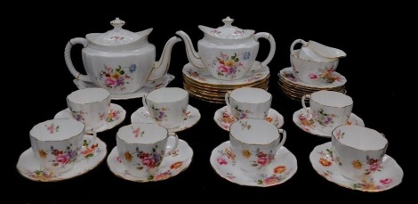 A Royal Crown Derby porcelain part tea service decorated in the Derby Posies pattern, comprising the two graduated tea pots, cream jug, sugar bowl, bread plate, seven salad plates, eight tea cups, saucers and plates.