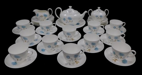 A Wedgwood porcelain tea service decorated in the Iced Rose pattern, comprising tea pot, cream jug and sucrier, a pair of bread plates, twelve tea cups, saucers and tea plates.