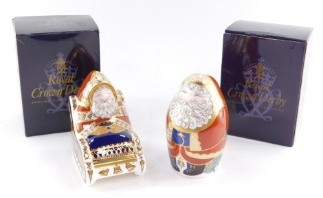 A Royal Crown Derby porcelain Imari paperweight modeled as Santa Claus, and another modeled as Santa and Sleigh, both boxed. (2)