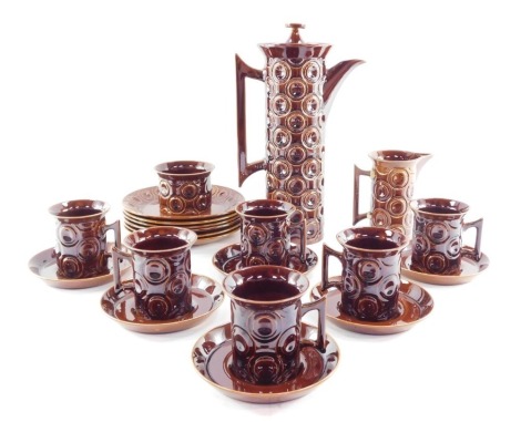 A Portmeirion brown glazed pottery part coffee service decorated in the Jupiter pattern, comprising coffee pot, cream jug, sugar bowl, six cups, saucers and plates. (AF)