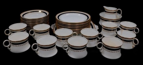 A Royal Albert late 19thC porcelain tea service, decorated with bands of flowers and leaves, in cobalt blue and gilt, printed marks, comprising bread plate, cream jug, sugar bowl, eleven tea cups, twelve saucers and tea plates.