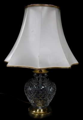 A Hampton cut glass table lamp, raised on a brass circular base, with a frilled octagonal shade, 48cm high.