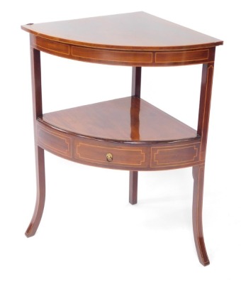A George III mahogany and box wood line inlaid corner washstand, with a single frieze drawer, raised on out swept legs, 84cm high, 70cm wide, 50.5cm deep.