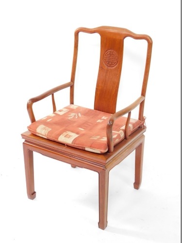 A Chinese hardwood open armchair, the solid splat carved with a central roundel, with a solid seat on shaped legs.