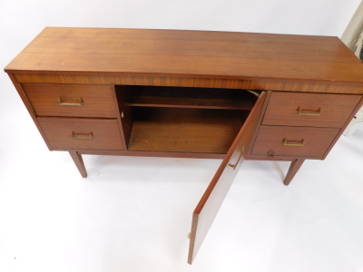 A 1960s/70s teak small sideboard cabinet, with a cross banded frieze, above a large door, flanked by two pairs of doors, on tapering feet, 74cm high, 140cm wide. - 3