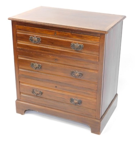 A Continental walnut chest of drawers, the cross banded top with a moulded edge, three drawers each with pressed Art Nouveau style handles on bracket feet, 83cm high, 77cm wide.