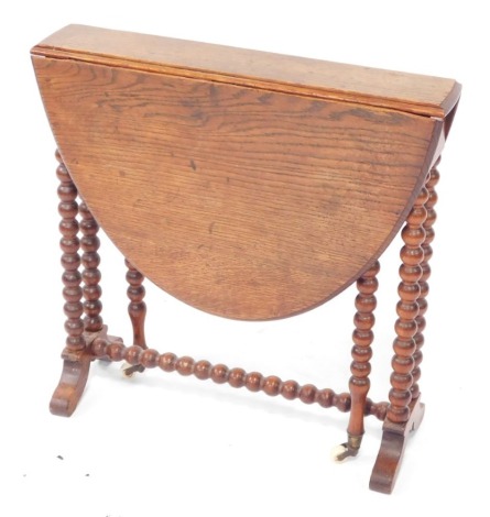 A late 19thC oak Sutherland table, the oval top with a moulded edge, on bobbin turned supports, with splayed legs, 59cm wide.