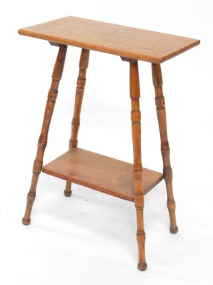 An early 20thC oak occasional table, the rectangular top on turned supports, with under tier, the top 50cm wide.