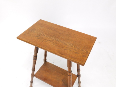 An early 20thC oak occasional table, the rectangular top on turned supports, with under tier, the top 50cm wide. - 2