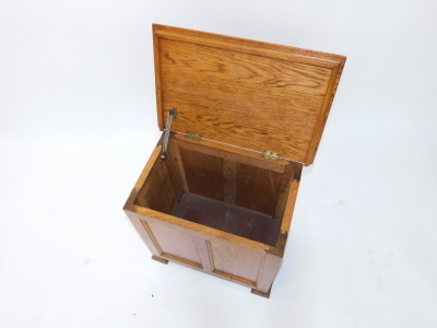 An oak Arts & Crafts workbox, the hinged lid with a moulded edge, above a paneled front on block feet, 51cm wide. - 3