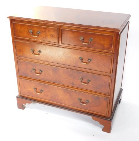 A burr elm veneered chest of drawers, the top with a moulded edge, two short with three long drawers, drop handles, on bracket feet, 94cm high, 94cm wide.
