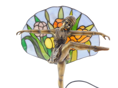 A Lorenzl style figural table lamp, modeled as an exotic dancer, with a floral stained glass back drop, 39cm high. - 2