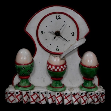 An Orval Creations French novelty wall clock, dial bearing Arabic numerals at quarters, the plaster case moulded as three egg cups, bears paper label, 25cm high.