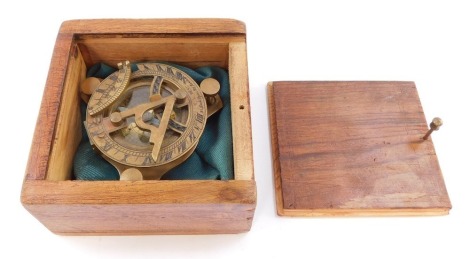 A brass compass by F L West, 31 Lockspur, London, boxed.