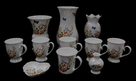 A group of Aynsley porcelain decorated in the Cottage Garden pattern, including vases, a heart shaped dish, and six cups.