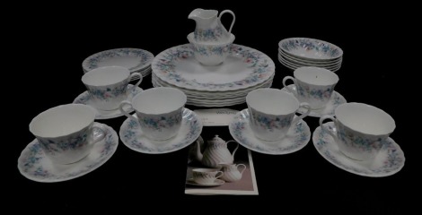 A Wedgwood porcelain part dinner and tea service decorated in the Angela pattern, comprising seven dinner plates, six fruit bowls, cream jug, sugar bowl, six tea cups, saucers and plates.