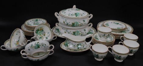 A Crown Staffordshire porcelain part dinner and tea service decorated in the Kowloon pattern, comprising oval meat platter, a pair of vegetable tureens and covers, sauce boat on stand, six dinner and dessert plates, six soup cups and three saucers, five t