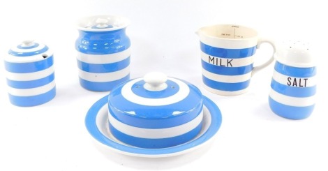 A group of T G Green blue banded Cornish ware, comprising a muffin dish and cover, jar and cover, flour sifter and a preserve pot and cover, together with a similar banded milk jug. (5)