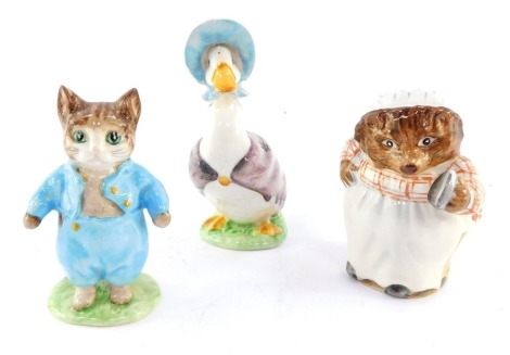 A Beswick Beatrix Potter figure modeled as Mrs Tiggywinkle, gold back stamp, together with a figure of Jemima Puddleduck and Tom Kitten, brown back stamp. (3)