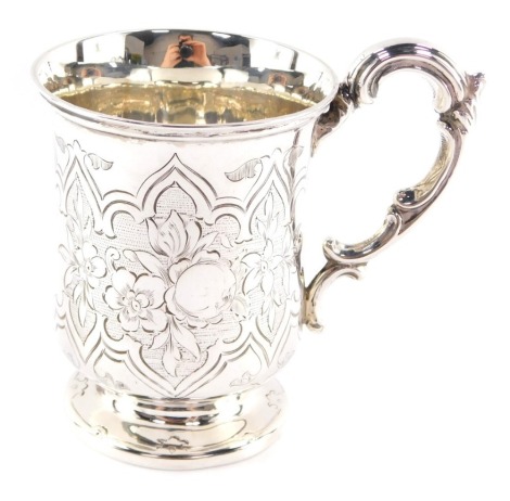 A Victorian silver tankard, engraved with flowers and fruit, within Gothic tracery, William Hunter & Son, London, 1874, 4.73oz.