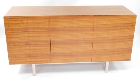 An Italian cherry wood sideboard, with three doors opening to reveal shelves, raised on square metal legs, 80cm high, 150cm wide, 47cm deep.