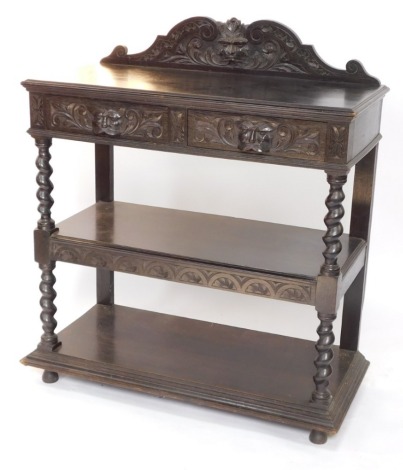 A Victorian ebonised oak buffet, with a foliate carved back, above two frieze drawers with mask handles, over two further tiered shelves, united by spiral twist supports, raised on club feet, 125cm high, 106cm wide, 49cm deep.