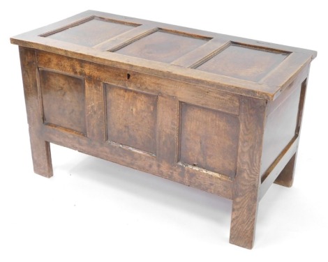 A 17thC oak coffer, with a triple paneled front, raised on straight legs, 80cm high, 108cm wide, 51.5cm deep.