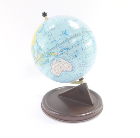 A Chad Valley mid century tin plate terrestrial globe, raised on a brown base, 27cm high.