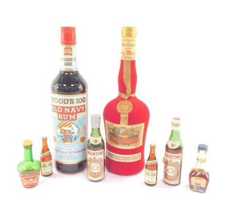 A bottle of Wood's 100 Proof Old Navy Rum, Marnier-Lapostolle Cherry Marnier, and miniature bottles, including Martini.  (8)