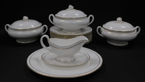 A Royal Worcester porcelain part dinner service decorated in the Contessa pattern, comprising oval meat platter, three vegetable tureens and covers, sauce boat on stand and ten dinner plates.