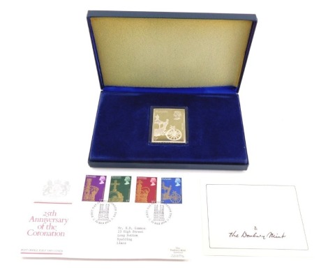 A Danbury Mint 25th Anniversary of The Coronation silver collectors stamp, with first day cover envelope and care instruction leaflet, boxed.