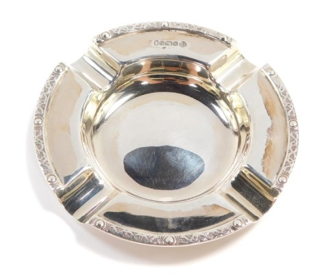 A silver ashtray, with Celtic type bordered detail, maker's stamp FH, Sheffield 1977, 10cm wide, 2½oz.