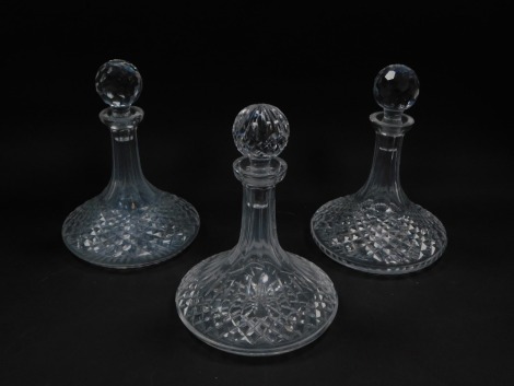 Three cut glass ship's decanters, comprising a pair with pentagon top and another with diamond design. (3)