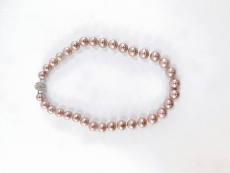 A simulated pearl necklace, with light pink lustre and knotted string strand, with diamonte finish, screw in clasp, 54cm long overall.