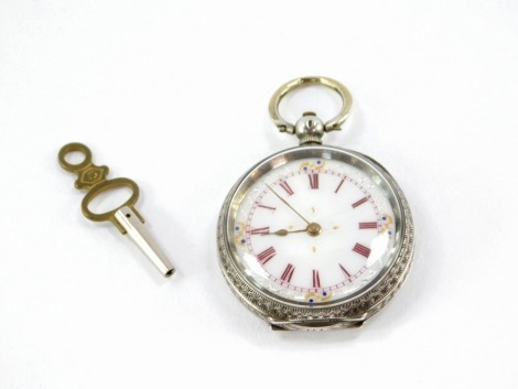 A silver pocket watch, with white enamel dial, with pink Roman numerals and gilt applied scroll detailing, in a hammered scroll case with a vacant cartouche, stamped 935, with key, 35.3g all in.