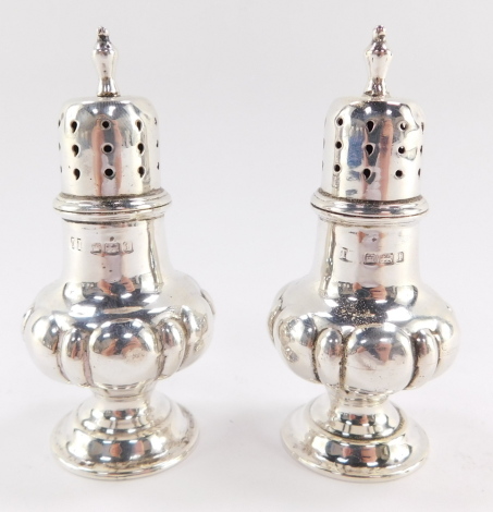 A pair of George V silver salt and pepper pots, of semi fluted baluster form, Sheffield 1911, 8cm high, 1¾oz.