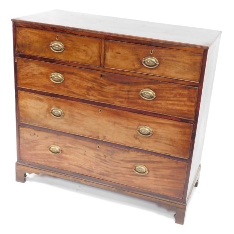 A George III mahogany chest of drawers, with a moulded edge, above two short and three long drawers, each with oval pressed brass handles, on bracket feet, 102cm high.