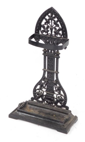 A Victorian cast iron umbrella stand, decorated with flowers and leaves, above a rectangular base with drip tray, later replacement band for umbrellas, 74cm high.