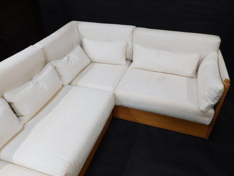 A modular pine sofa, upholstered in pattern cream fabric, with leather ties, in three sections. The upholstery in this lot does not comply with the 1988 (Fire & Fire Furnishing) Regulations, unless sold to a known exporter or upholsterer it will be cut fr