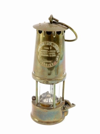 A brass Protector Lamp Company miner's lamp, 23cm high.