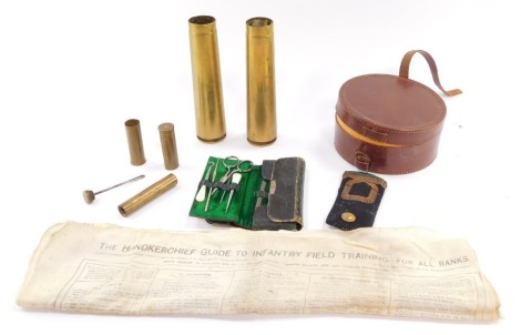 A collection of military items, to include a Handkerchief Guide To Infantry Field Training, For All Ranks, 6th edition., various brass cases, bearing military mark, shells, single naval sub-lieutenant's epaulette, early 20thC sewing kit, etc. (a quantity)