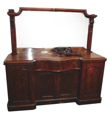 A Victorian figured mahogany mirror back sideboard, the top with a leaf and scroll carved crest, above a rectangular mirror plate, the inverted breakfront base with a shaped moulded edge, above a frieze drawer and two panelled doors flanked by two long pa