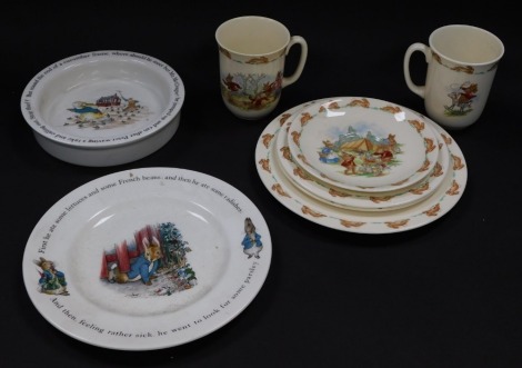 A group of Royal Doulton Bunnykins table wares, comprising two mugs, saucer, pair of tea plates and a breakfast plate, together with a Wedgwood Peter Rabbit plate and a baby's dish. (a quantity)