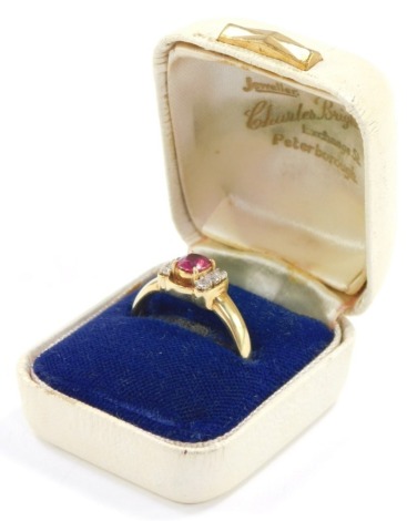 A ruby and diamond ring, the claw set oval cut ruby flanked by shoulders, each set with three diamonds, in yellow metal, stamped 18k, size S, 4.4g.