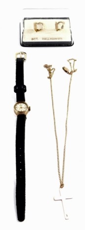 A 9ct gold cross on a neck chain, together with a pair of hoop earrings, 4.0g., and a Trident lady's 9ct gold cased wristwatch, circular silvered dial, on a leather strap. (3)