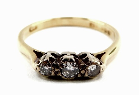 An 18ct gold and diamond three stone ring, approx 1/6th carat, size J, 2.5g.