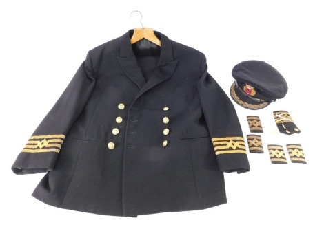 A Merchant Navy captain's uniform, comprising jacket, trousers and peaked cap, arm bands, epaulettes, etc.