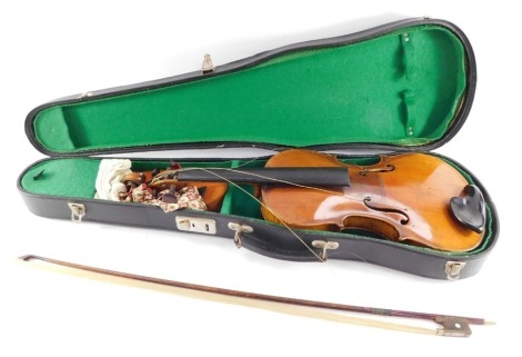 A violin with a two piece back, rosewood keys, and a bow, cased.